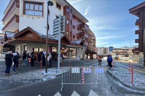 A street scene at a Swiss ski resort village with chalet-style buildings